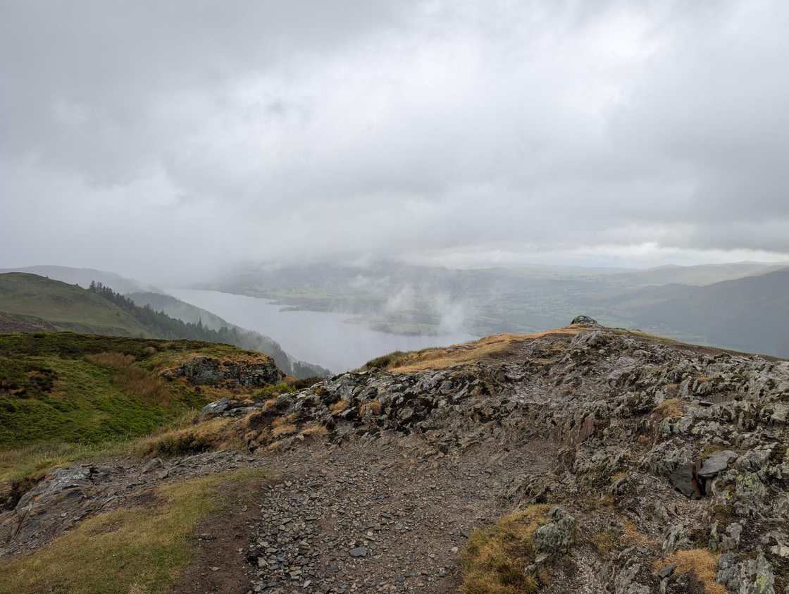 Barf - a rocky top above Bassenthwaite Lake, low cloud drifting across the water under a grey overcast sky
