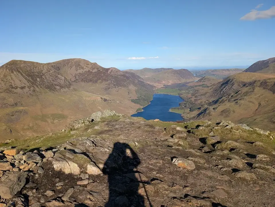 Fleetwith Pike - a rocky summit looking down over Buttermere cradled between fells, Crummock Water beyond