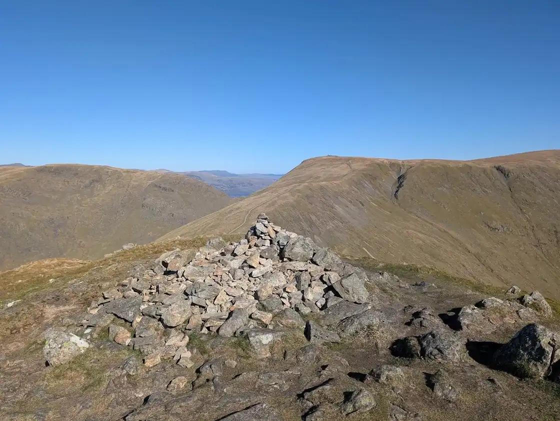 Froswick - rolling fells and valleys falling away to Windermere shining in the distance, under deep blue sky