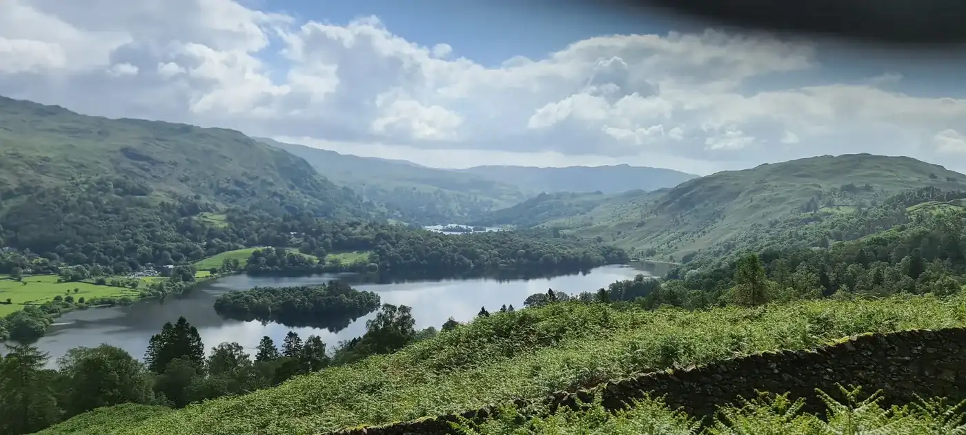 Silver How - a green view down over Grasmere and its island, Rydal Water beyond among lush wooded fells