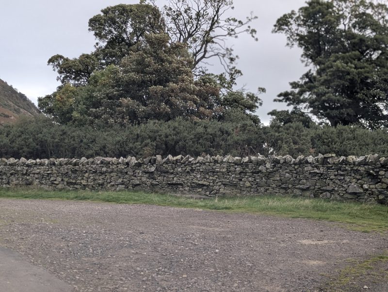Gravel layby beside a drystone wall