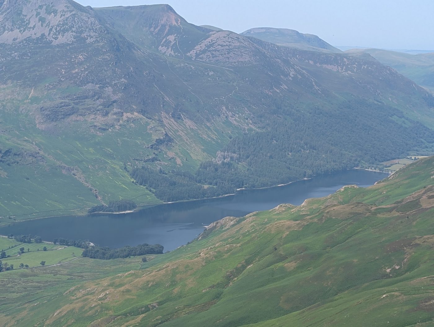 Buttermere far below the ridge between Dale Head and Hindscarth, with the fells across the valley in hazy summer sunshine